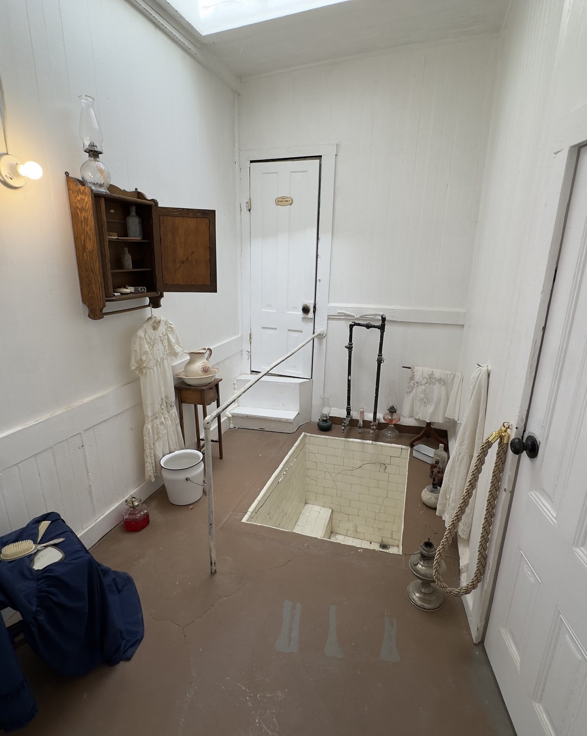 The original sunken tile mineral bath at The Crescent House, lit from a skylight above, from its days as the Crescent Bath House