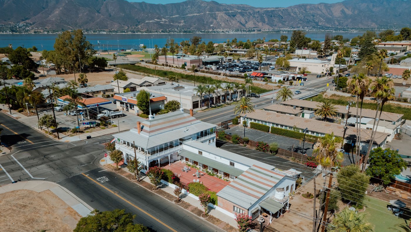 An aerial view of The Crescent House 1887 with Lake Elsinore and the mountains behind it